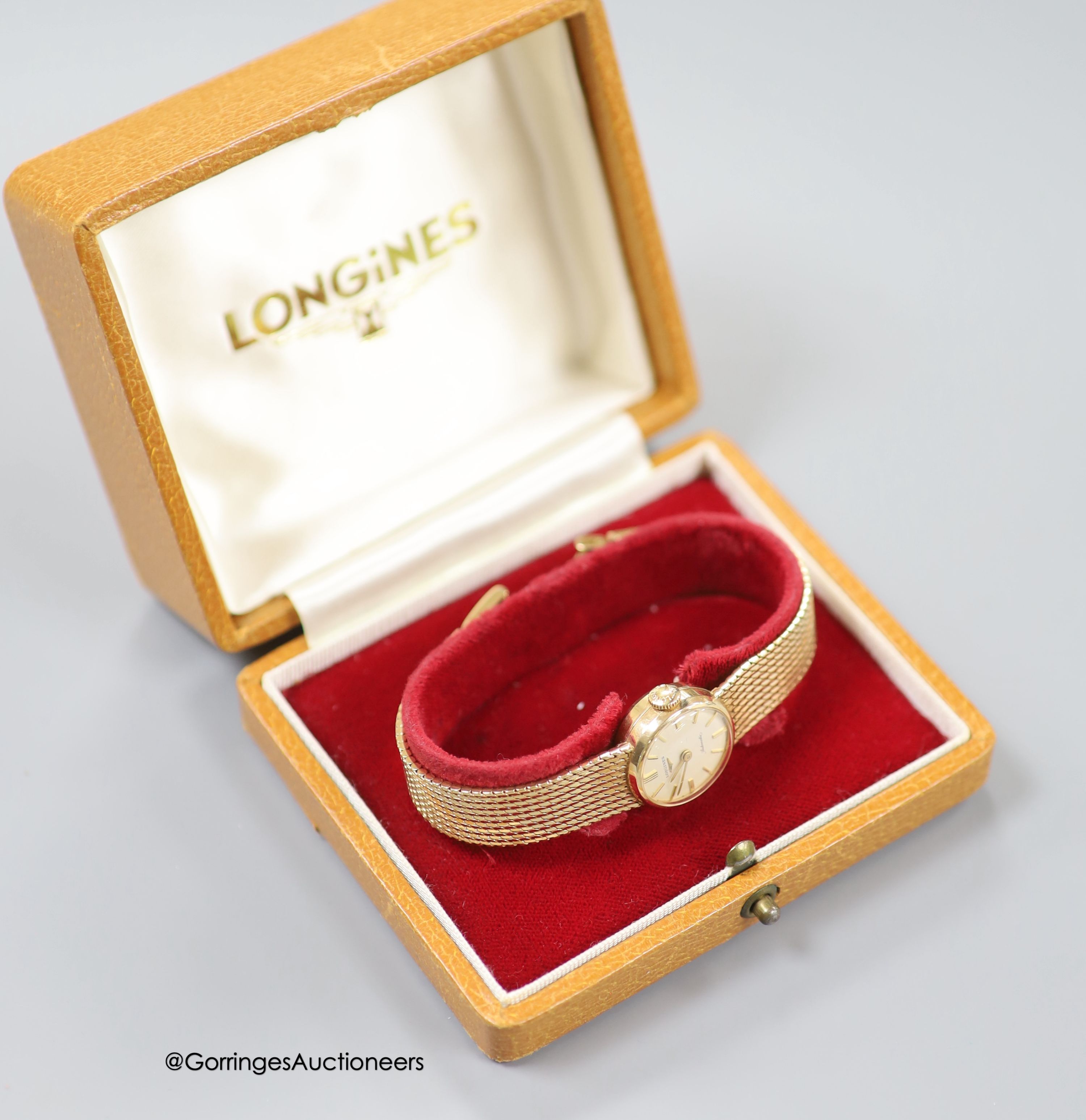 A lady's 9ct gold Longines manual wind wrist watch, on a 9ct gold bracelet, case diameter 20mm, gross weight 31.1 grams, in Longines box.